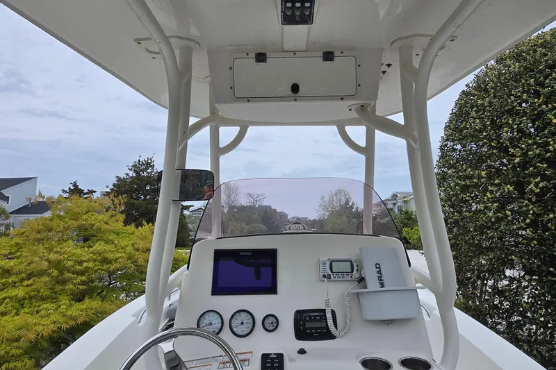 Slide: The Image of 2021 NauticStar 2302 Legacy boat console with gauges and navigation equipment. - 9