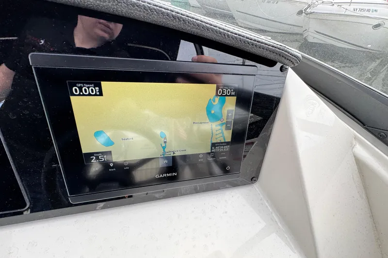 Slide: The Image of Garmin navigation display on 2024 Stingray 211 DC boat dashboard. - 10