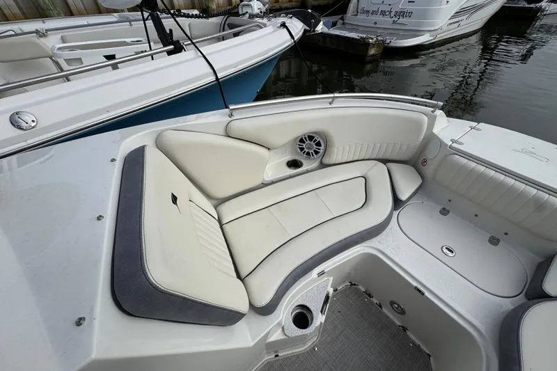 Slide: The Image of 2024 Stingray 211 DC boat interior with white seating and speaker system. - 18