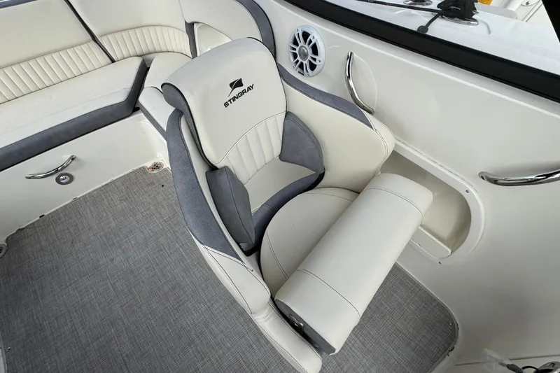 Slide: The Image of 2024 Stingray 211 DC boat interior with plush seating and modern design. - 25