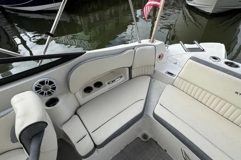 Slide: The Image of 2024 Stingray 211 DC boat interior with plush seating and cup holders. - 28