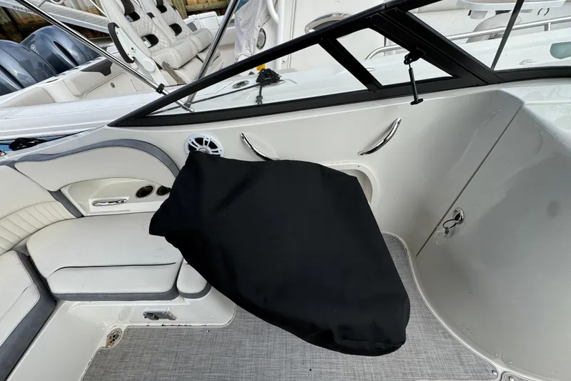 Slide: The Image of 2024 Stingray 211 DC boat interior with covered console and seating area. - 30