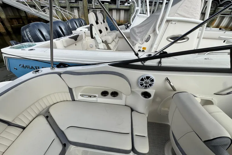 Slide: The Image of 2024 Stingray 211 DC boat interior with seating and speaker system. - 5