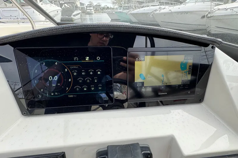 Slide: The Image of Dashboard of a 2024 Stingray 211 DC boat with digital displays. - 8