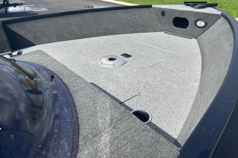 Slide: The Image of Bow deck of 2019 Starweld Fusion Pro 16 SC boat, featuring carpeted surface and storage compartments. - 10