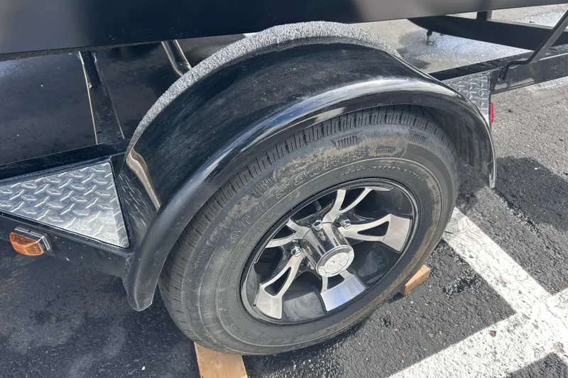 Slide: The Image of Trailer wheel of a 2019 Starweld Fusion Pro 16 SC on a parking lot. - 14