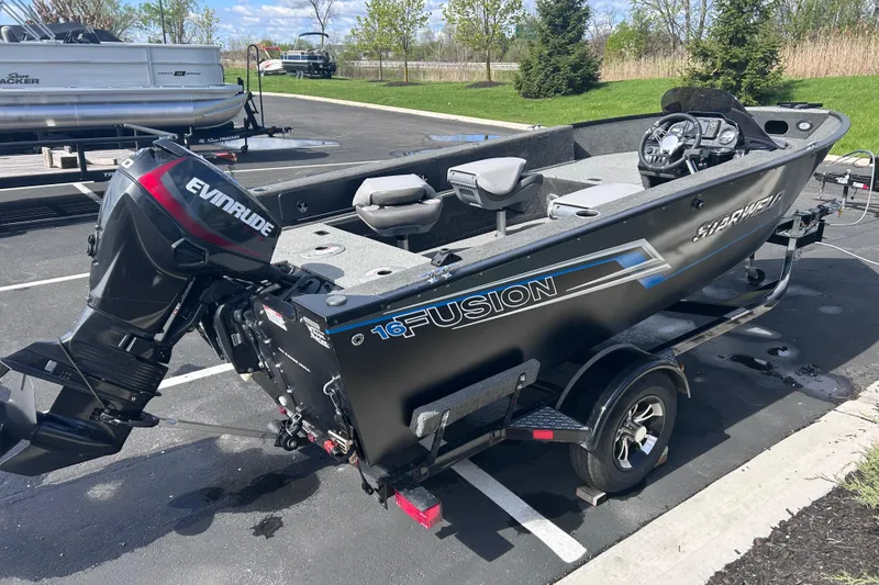 Slide: The Image of 2019 Starweld Fusion Pro 16 SC boat with Evinrude motor in parking lot. - 7