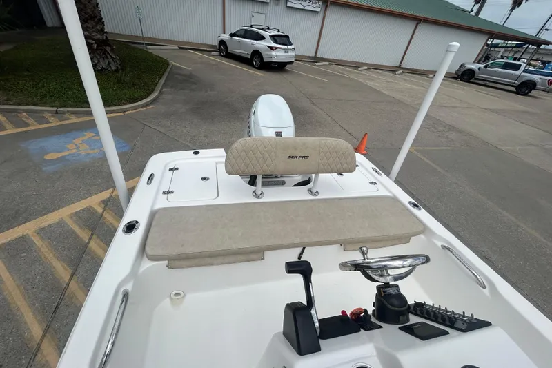 Slide: The Image of 2022 Sea Pro 172 Bay boat interior with steering wheel and seating in a parking lot. - 10