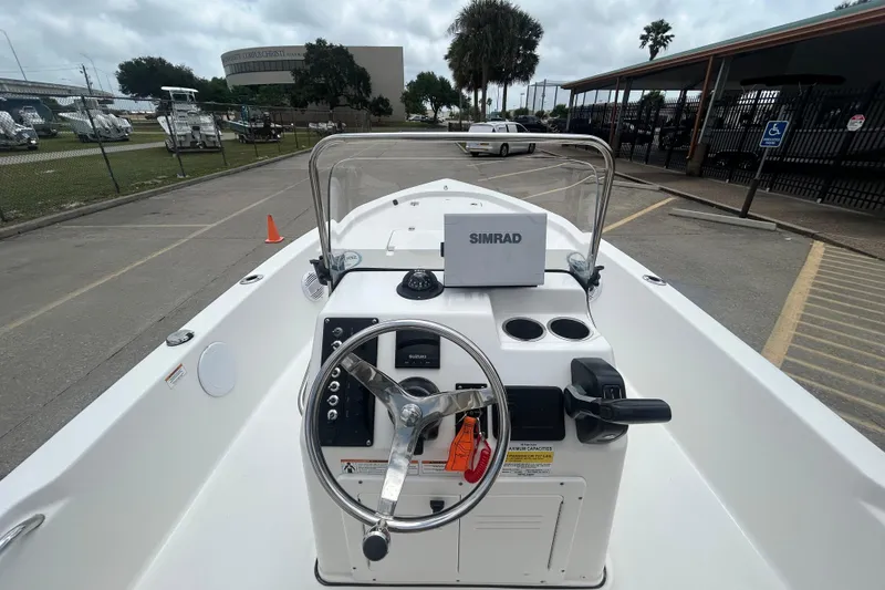 Slide: The Image of 2022 Sea Pro 172 Bay boat dashboard with steering wheel and Simrad navigation system. - 11