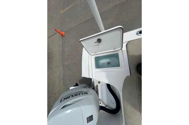 Slide: The Image of 2022 Sea Pro 172 Bay boat with Suzuki outboard motor and open storage compartment. - 13
