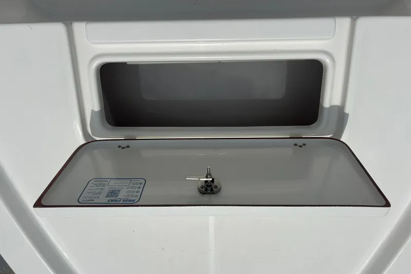 Slide: The Image of 2022 Sea Pro 172 Bay boat compartment with open hatch and visible label. - 6