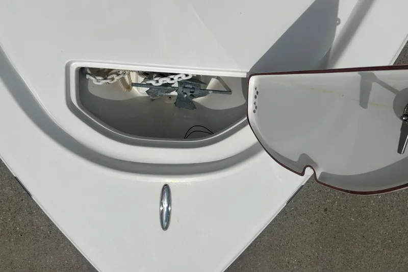 Slide: The Image of 2022 Sea Pro 172 Bay boat anchor compartment with chain and sunglasses. - 7