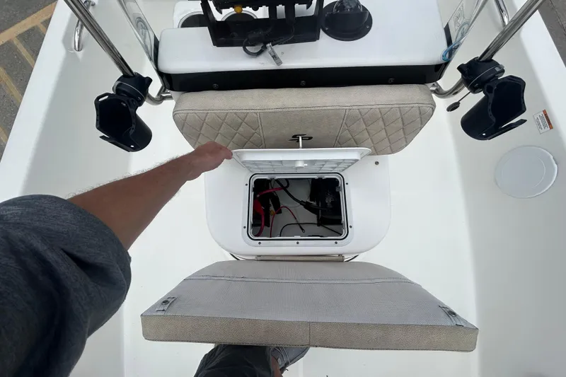 Slide: The Image of 2022 Sea Pro 172 Bay boat interior with open storage compartment and fishing rod holders. - 9