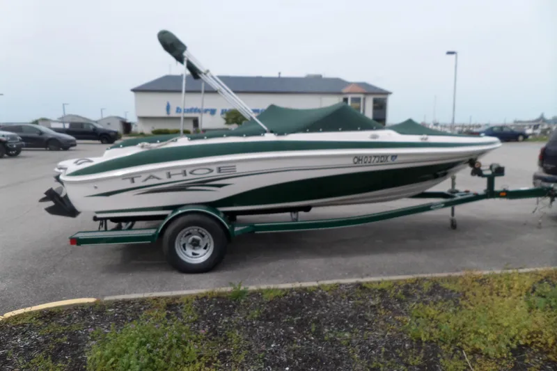 Slide: The Image of 2005 Tahoe Q4 Sport boat on trailer in parking lot. - 10