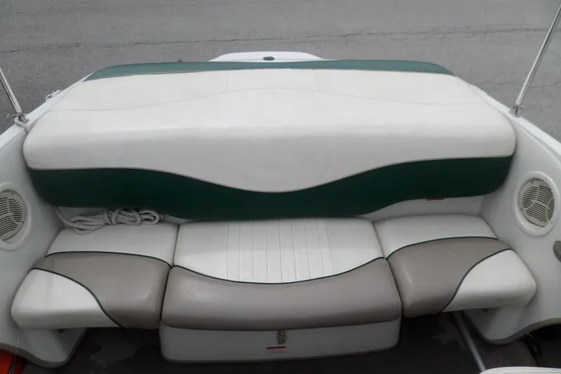 Slide: The Image of 2005 Tahoe Q4 Sport boat seating with green and white upholstery. - 12