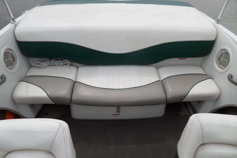Slide: The Image of 2005 Tahoe Q4 Sport boat interior with white and green seating. - 13