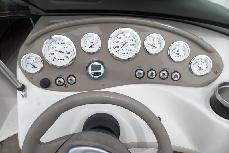 Slide: The Image of Dashboard of a 2005 Tahoe Q4 Sport boat with gauges and controls. - 16