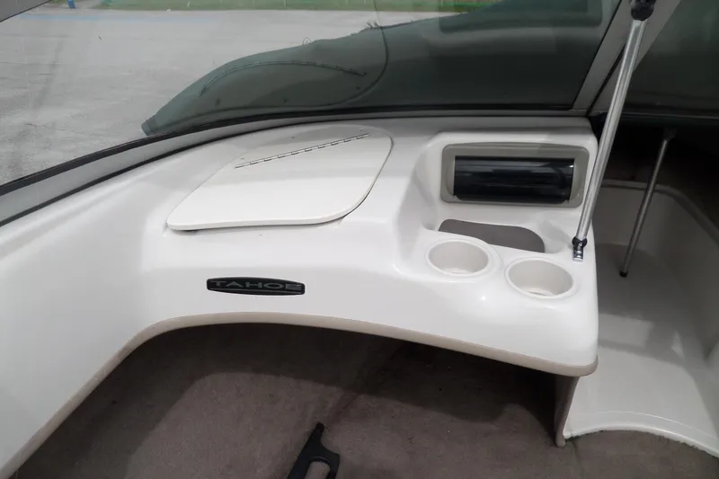 Slide: The Image of 2005 Tahoe Q4 Sport boat interior with cup holders and storage compartment. - 18