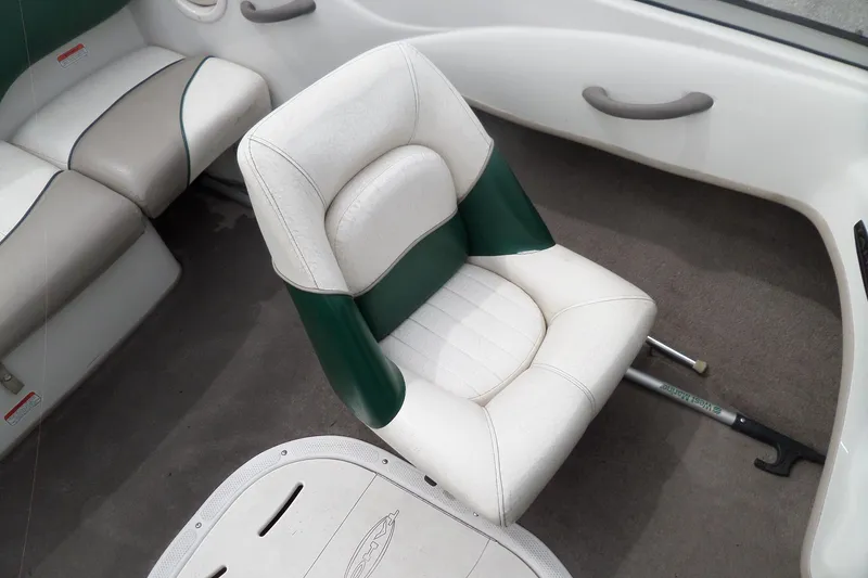 Slide: The Image of 2005 Tahoe Q4 Sport boat interior with white and green seating. - 19