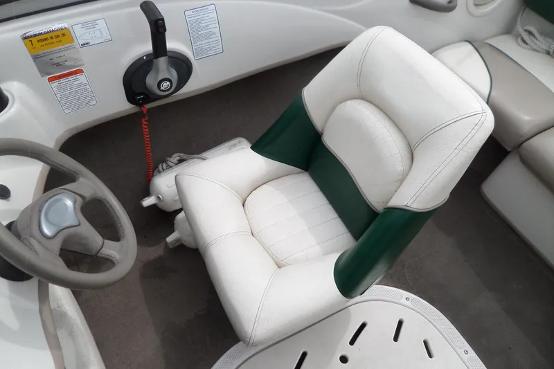 Slide: The Image of 2005 Tahoe Q4 Sport boat interior with steering wheel and cushioned seat. - 20