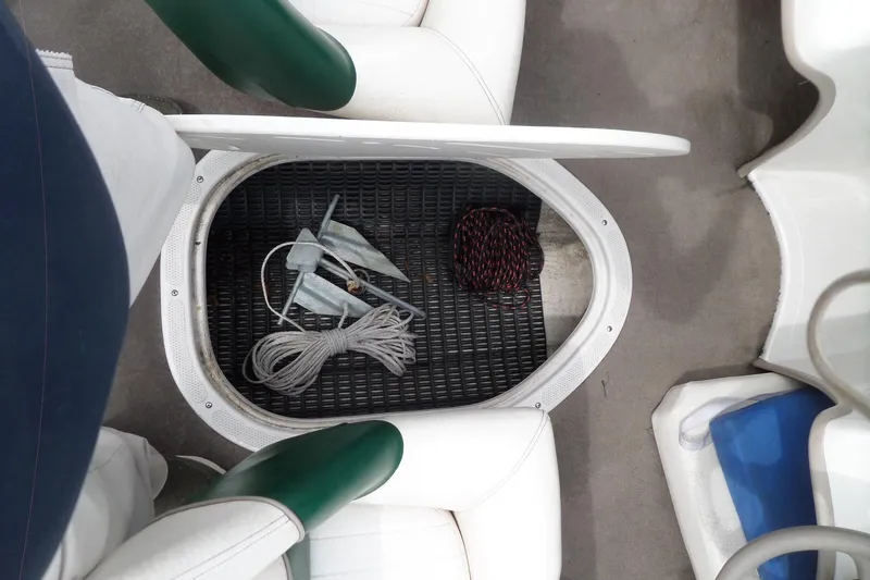 Slide: The Image of Storage compartment in a 2005 Tahoe Q4 Sport boat with ropes and anchor. - 21