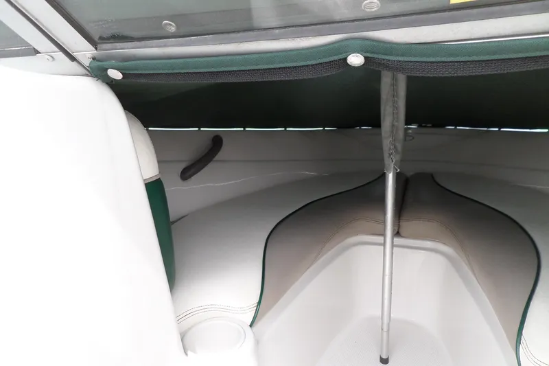 Slide: The Image of 2005 Tahoe Q4 Sport boat interior with seating and canopy support pole. - 23