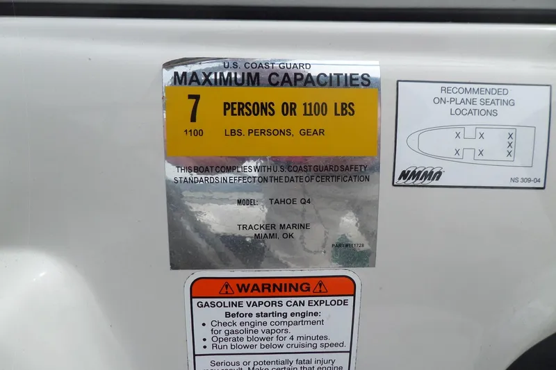 Slide: The Image of 2005 Tahoe Q4 Sport boat capacity label, seating diagram, and gasoline warning. - 24