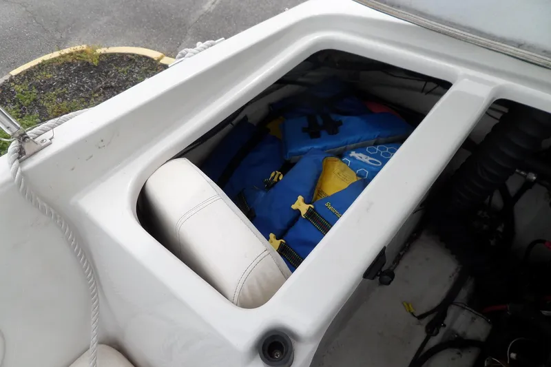 Slide: The Image of Storage compartment in a 2005 Tahoe Q4 Sport boat with life jackets inside. - 28