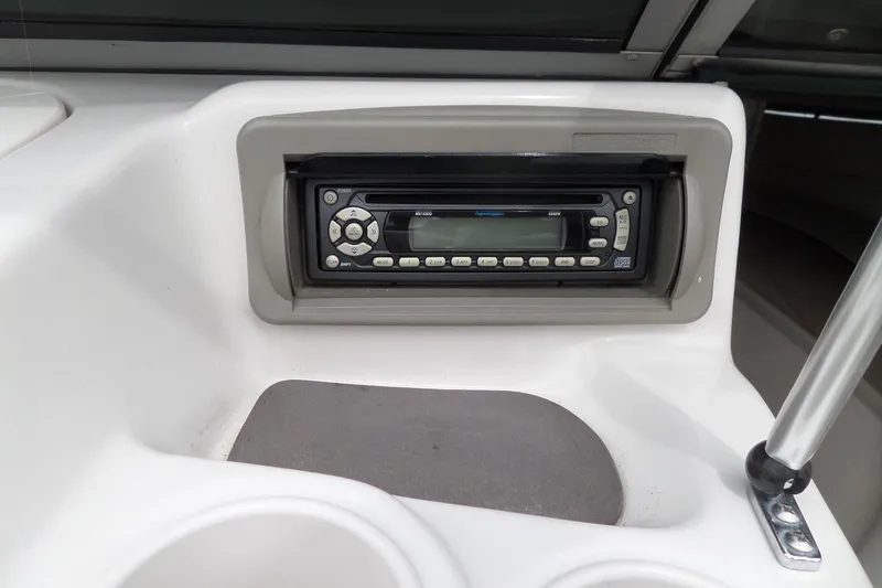 Slide: The Image of 2005 Tahoe Q4 Sport boat dashboard with built-in stereo system. - 30