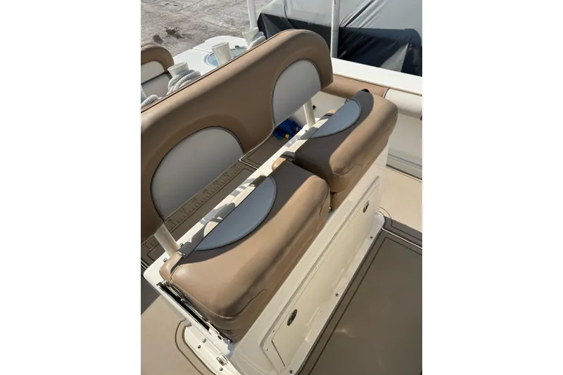 Slide: The Image of 2021 Sea Born LX24 Center Console boat seating with tan cushions and storage. - 10