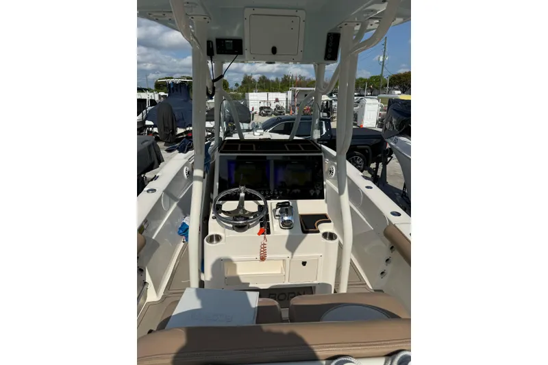 Slide: The Image of 2021 Sea Born LX24 Center Console boat interior with steering wheel and controls. - 11