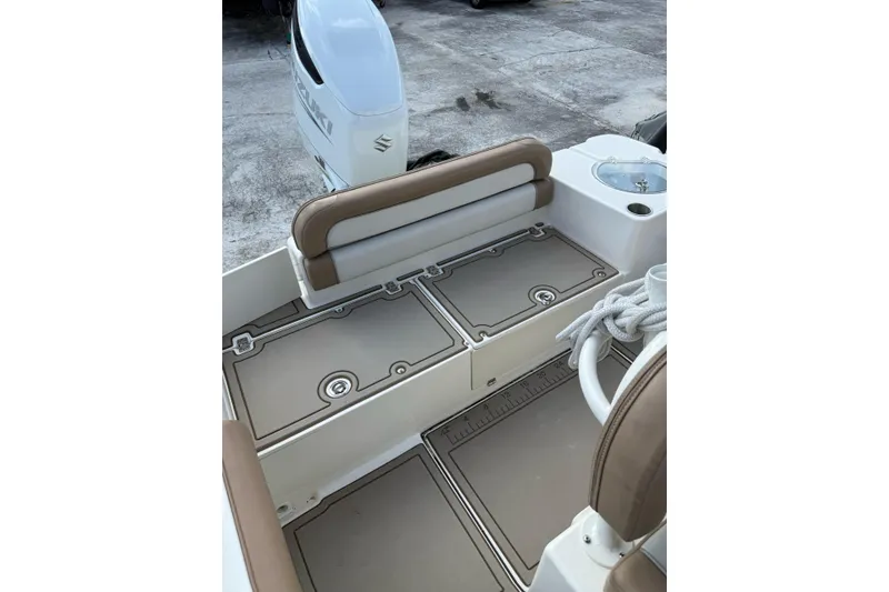 Slide: The Image of 2021 Sea Born LX24 Center Console boat interior with Suzuki engine, featuring seating and storage. - 12