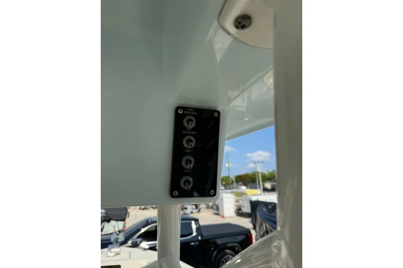 Slide: The Image of Control panel on a 2021 Sea Born LX24 Center Console boat, featuring various switches. - 16