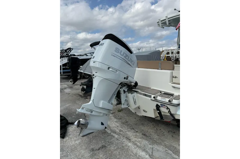 Slide: The Image of 2021 Sea Born LX24 Center Console with Suzuki outboard motor, parked outdoors. - 17