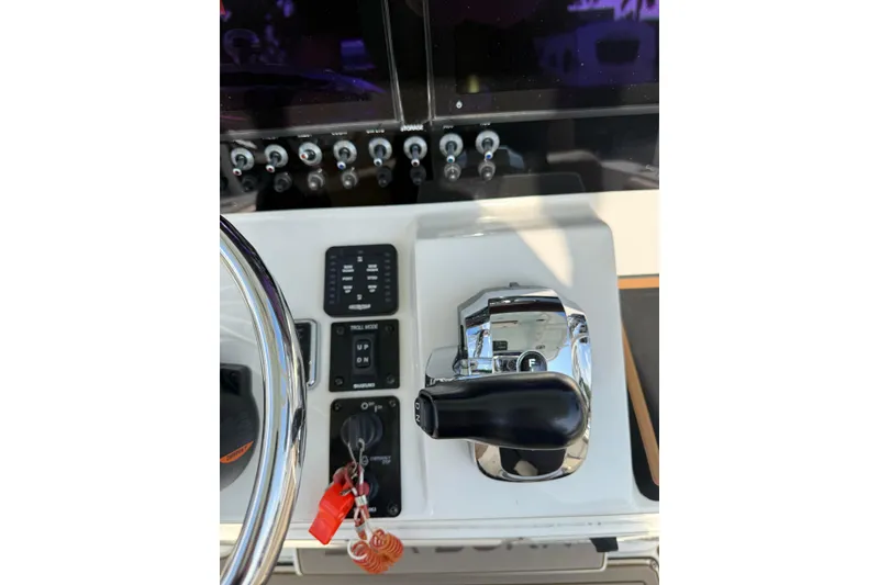 Slide: The Image of 2021 Sea Born LX24 Center Console boat dashboard with controls and steering wheel. - 20