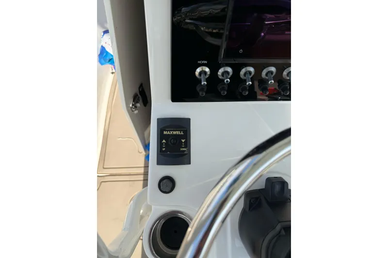 Slide: The Image of Control panel of a 2021 Sea Born LX24 Center Console boat with Maxwell controls. - 21