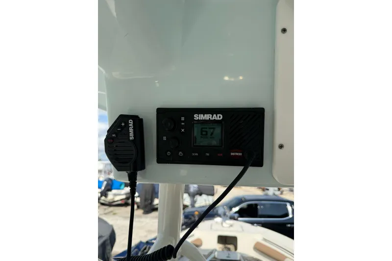 Slide: The Image of Simrad marine radio on 2021 Sea Born LX24 Center Console boat dashboard. - 22