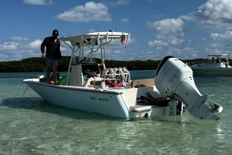 Slide: The Image of 2021 Sea Born LX24 Center Console boat in shallow, clear water under a blue sky. - 3