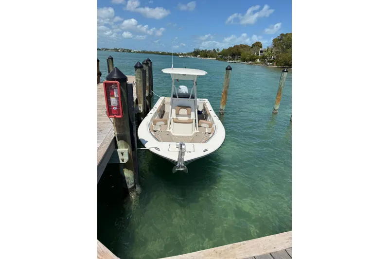 Slide: The Image of 2021 Sea Born LX24 Center Console boat docked in clear blue water. - 4