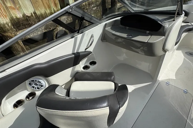 Slide: The Image of Interior of a 2019 Stingray 204 LR boat, featuring seating and cup holders. - 10