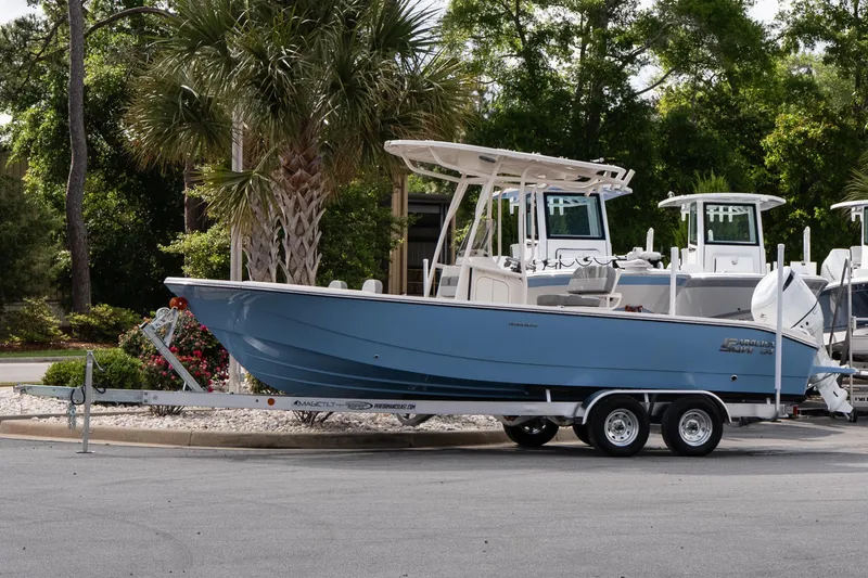 The Image of 2026 Carolina Skiff 24 Ultra Elite boat on trailer, parked outdoors. - 1