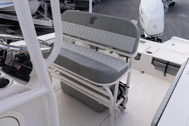 Slide: The Image of 2026 Carolina Skiff 24 Ultra Elite boat interior with seating and steering console. - 11
