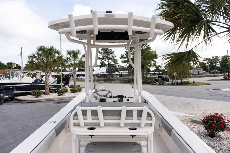 Slide: The Image of 2026 Carolina Skiff 24 Ultra Elite boat with T-top, parked near palm trees. - 6