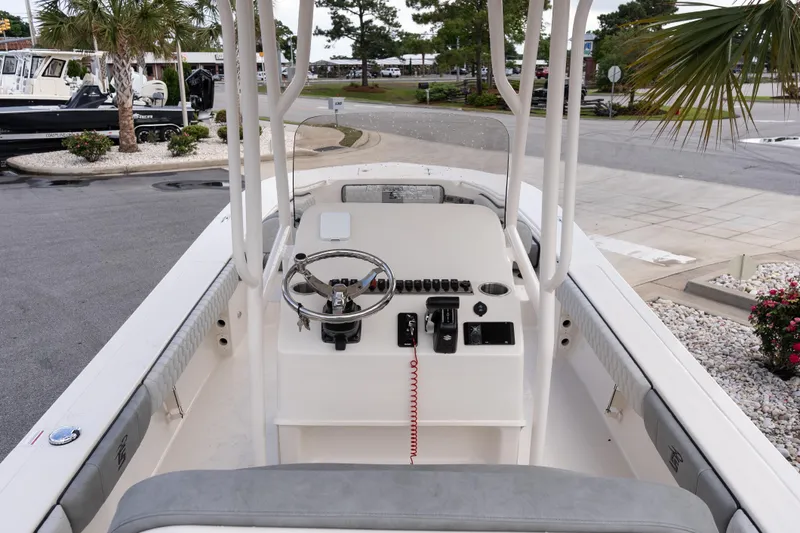 Slide: The Image of 2026 Carolina Skiff 24 Ultra Elite boat interior with steering console and seating. - 7