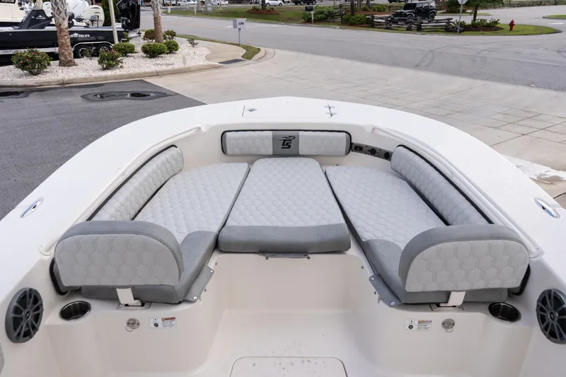 Slide: The Image of 2026 Carolina Skiff 24 Ultra Elite boat interior with cushioned seating and cup holders. - 8