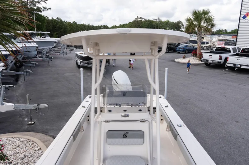 Slide: The Image of 2026 Carolina Skiff 24 Ultra Elite boat in a dealership lot, surrounded by other boats and vehicles. - 9