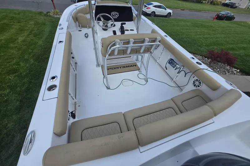 Slide: The Image of 2018 Sportsman Heritage 231 Center Console boat with beige seating and steering console. - 1