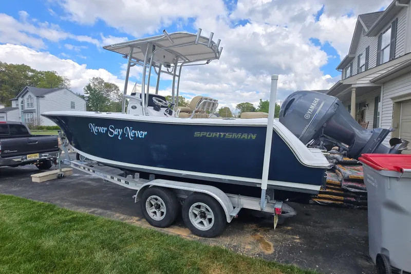 Slide: The Image of 2018 Sportsman Heritage 231 Center Console boat on trailer, labeled "Never Say Never." - 2
