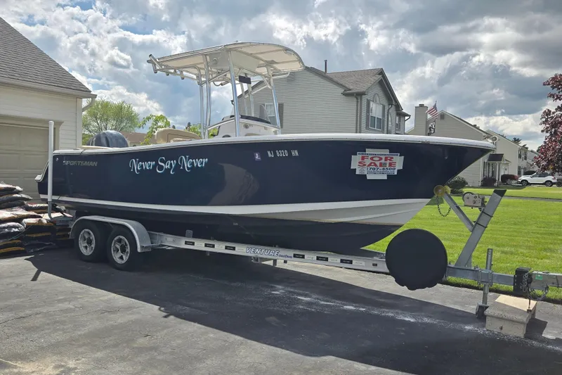 Slide: The Image of 2018 Sportsman Heritage 231 Center Console boat on trailer, "For Sale" sign displayed. - 4