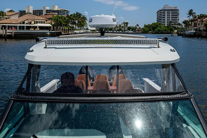 Slide: The Image of 2023 Saxdor 320 GTO cruising in a scenic waterfront setting. - 11